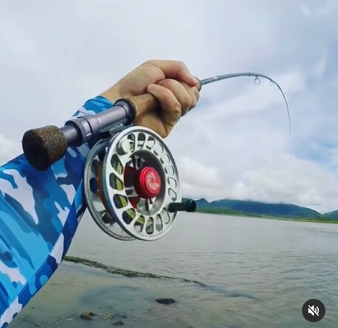 Image of a fisherman wearing camo SParms sun sleeves.