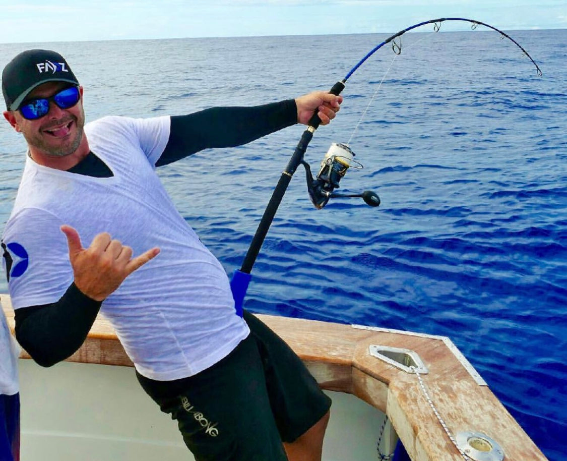 Image of a fisherman wearing SParms sun protective sleeves.