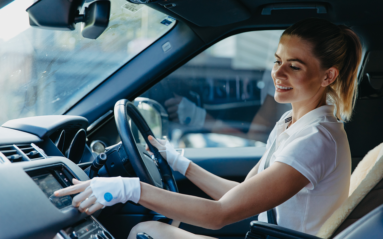 Image of a driver wearing SParms sun protective gloves.